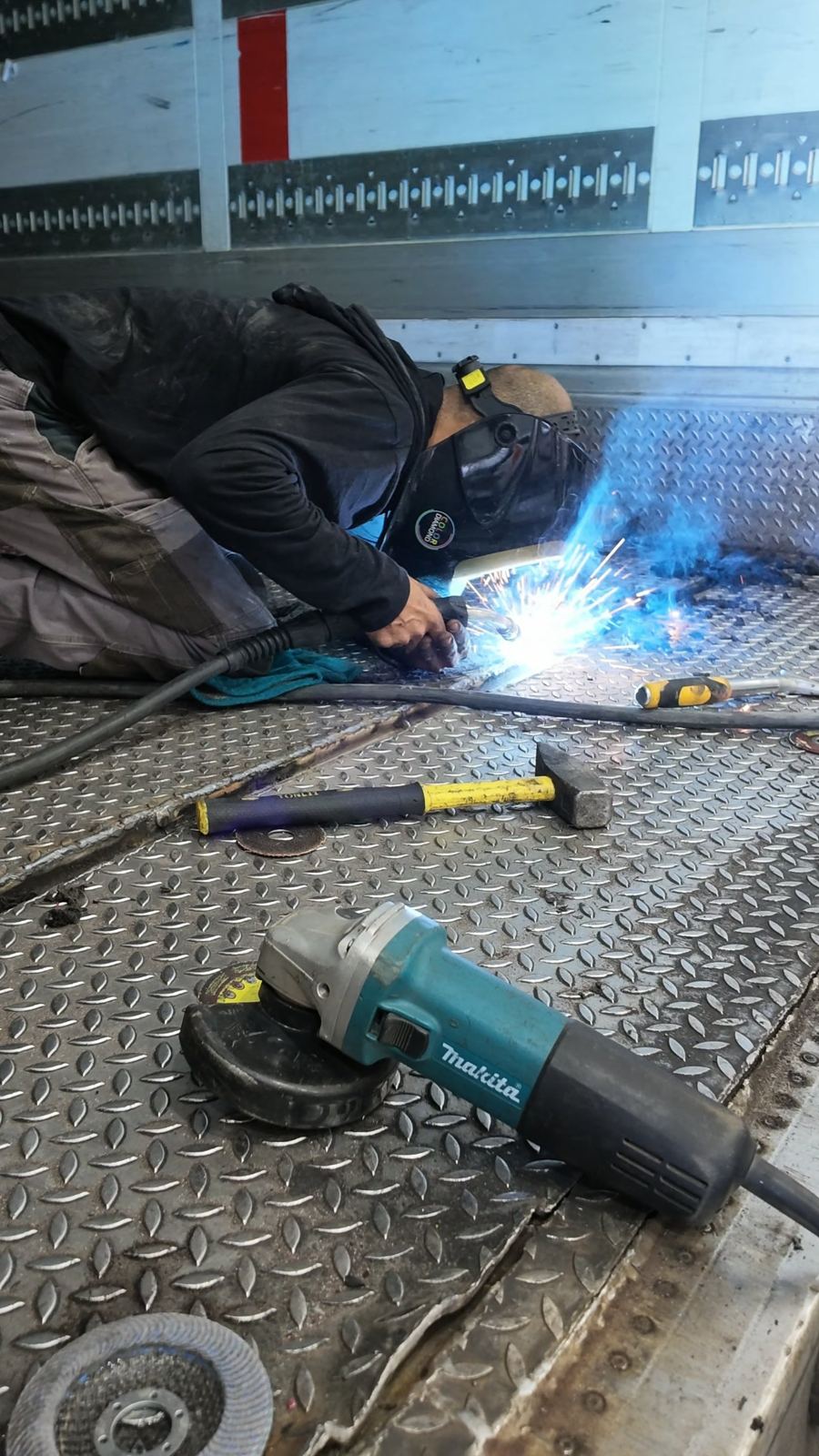 Welding repair on a truck body floor in the Taglit workshop